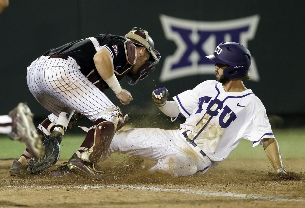 TCU second baseman Garrett Crain scores the game-winning run in the 16th inning to give the Horned Frogs a 5-4 victory over Texas A&M and earn a trip to Omaha, Neb. to play in the College World Series.