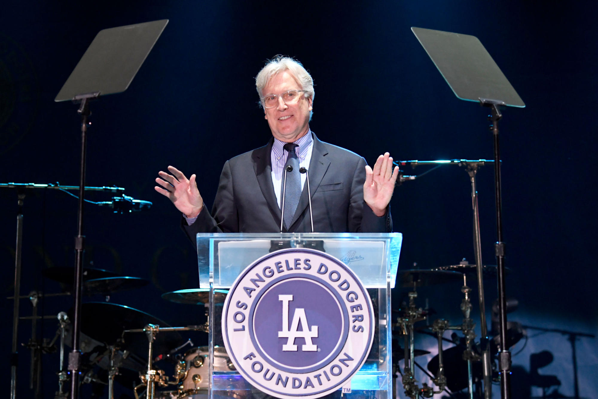 Dodgers majority owner Mark Walter stands at a podium and speaks to a crowd during a Dodgers Foundation gala