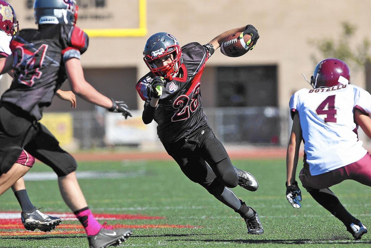 Chad Koste runs into the end zone for touchdown against West Covina Bulldogs in Costa Mesa Pop Warner Jr. Midget Orange Bowl at Estancia High School.