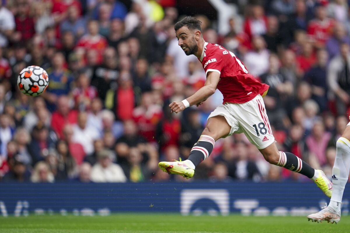 Manchester United's Bruno Fernandes scores his third goal during the English Premier League soccer match between Manchester United and Leeds United at Old Trafford in Manchester, England, Saturday, Aug. 14, 2021. (AP Photo/Jon Super)
