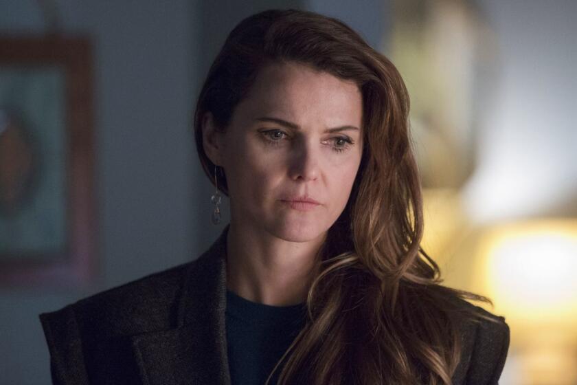 This image released by FX shows Keri Russell in a scene from "The Americans." Russell was nominated Thursday for an Emmy for outstanding lead actress in a drama series. The 70th Emmy Awards will be held on Monday, Sept. 17. (Eric Liebowitz/FX via AP)