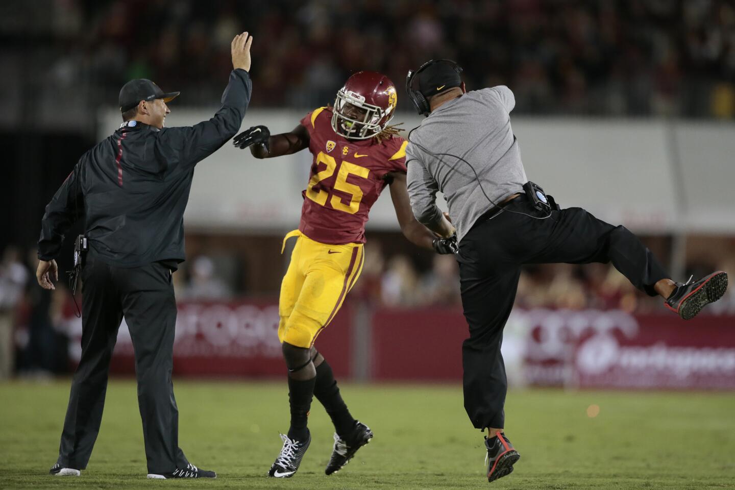 USC Coach Steve Sarkisian celebrates with tailback Ronald Jones after he scored a touchdown against Arkansas State in the third quarter on Saturday night at the Coliseum.