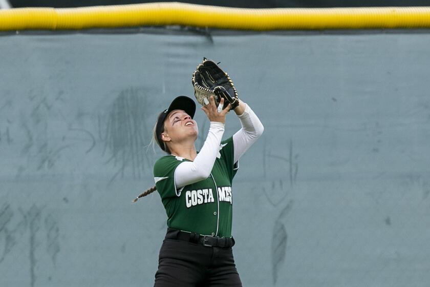 Costa Mesa's Annalee Mendoza makes a routine out on a fly ball to center field.