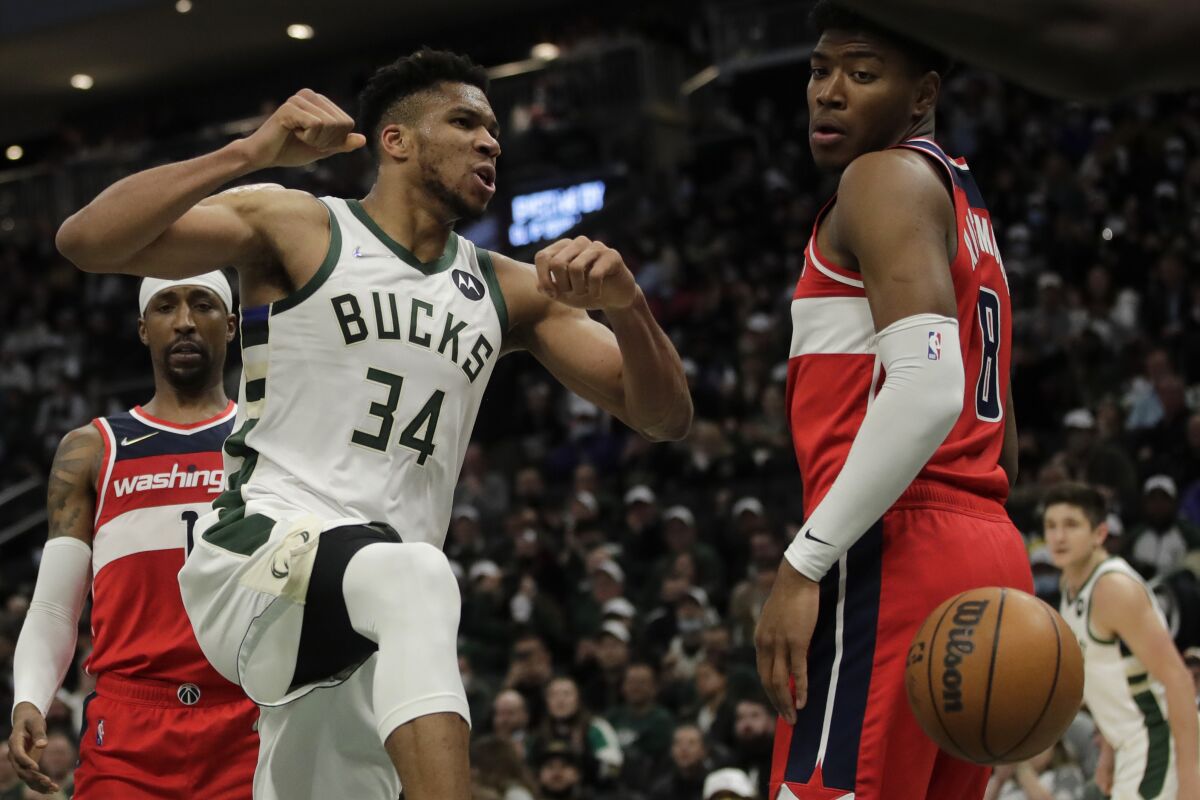 Milwaukee Bucks' Giannis Antetokounmpo (34) reacts after a dunk during the second half of an NBA basketball game against the Washington Wizards Tuesday, Feb. 1, 2022, in Milwaukee. (AP Photo/Aaron Gash)