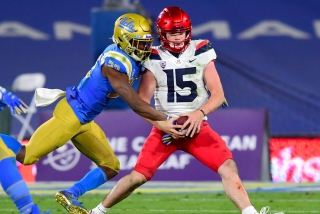 PASADENA, CA - NOVEMBER 28: Defensive back Obi Eboh #22 of the UCLA Bruins strips the ball.