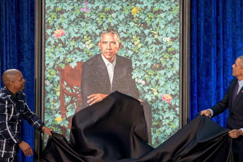 Former President Barack Obama, right, and Artist Kehinde Wiley, left, unveil Obama's official portrait at the Smithsonian's National Portrait Gallery, Monday, Feb. 12, 2018, in Washington. (AP Photo/Andrew Harnik)