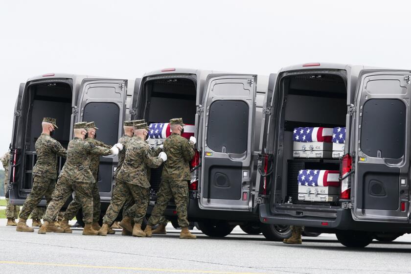 A Marine Corps carry team loads a transfer case containing the remains of Marine Corps Humberto Sanchez, 22, of Logansport, Ind., Sunday, Aug. 29, 2021, at Dover Air Force Base, Del. President Joe Biden embarked on a solemn journey Sunday to honor and mourn the 13 U.S. troops killed in the suicide attack near the Kabul airport as their remains return to U.S. soil from Afghanistan. (AP Photo/Manuel Balce Ceneta)