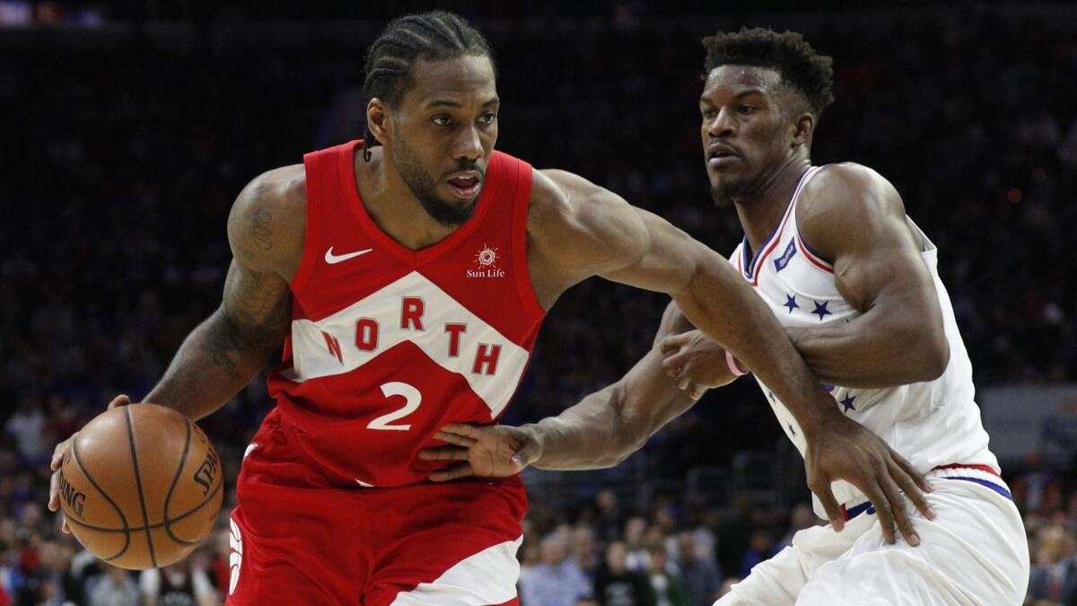 Raptors forward Kawhi Leonard (2) tries to drive past 76ers forward Jimmy Butler during the second half of Game 4 on Sunday.
