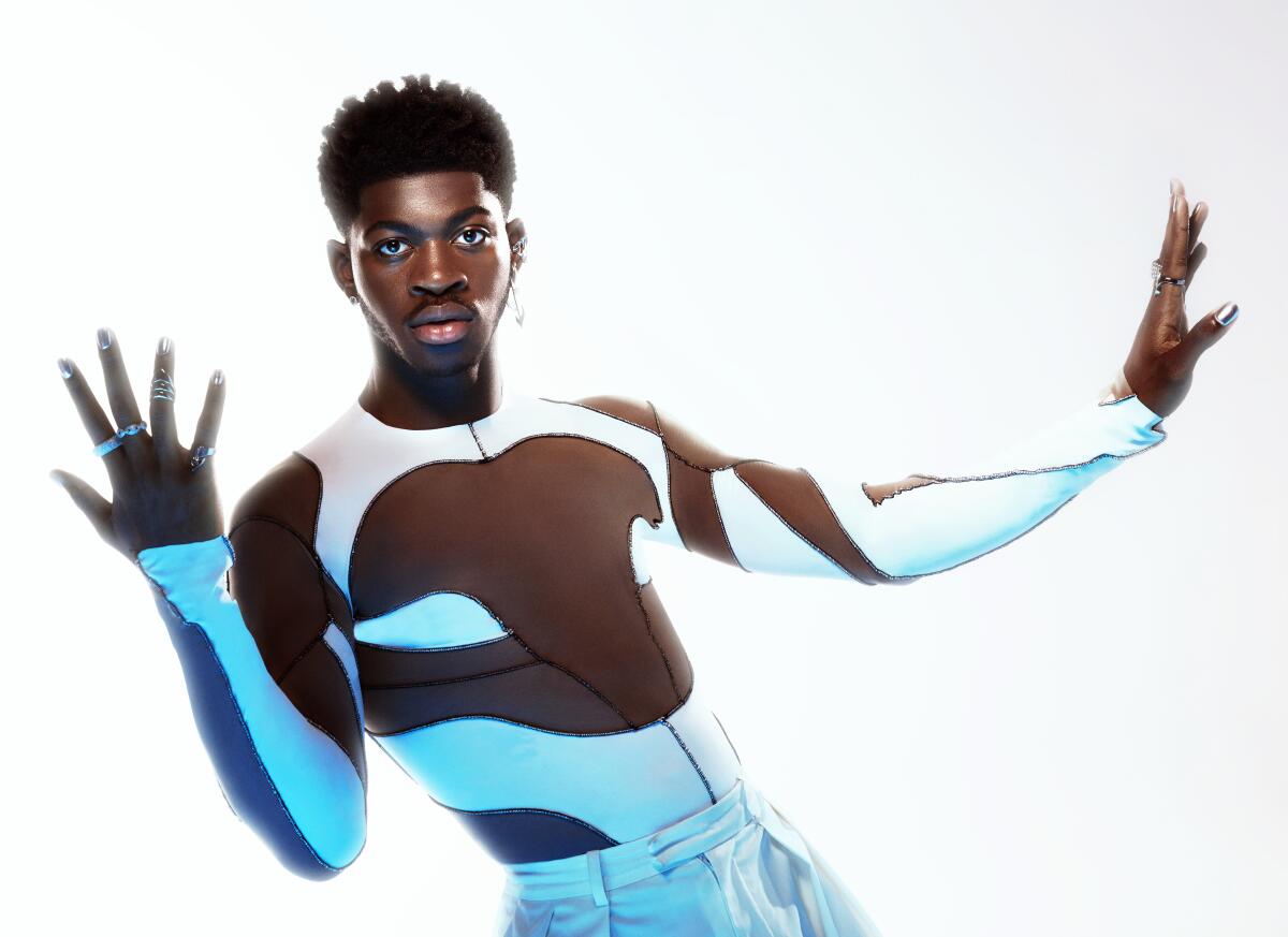 Lil Nas X poses in a Spiderman-esque body suit