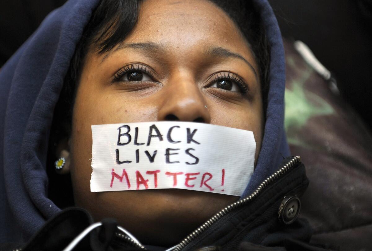 Student Zaniya Joe wears tape with the slogan 'Black lives matter' over her mouth at a Penn State protest in 2014.