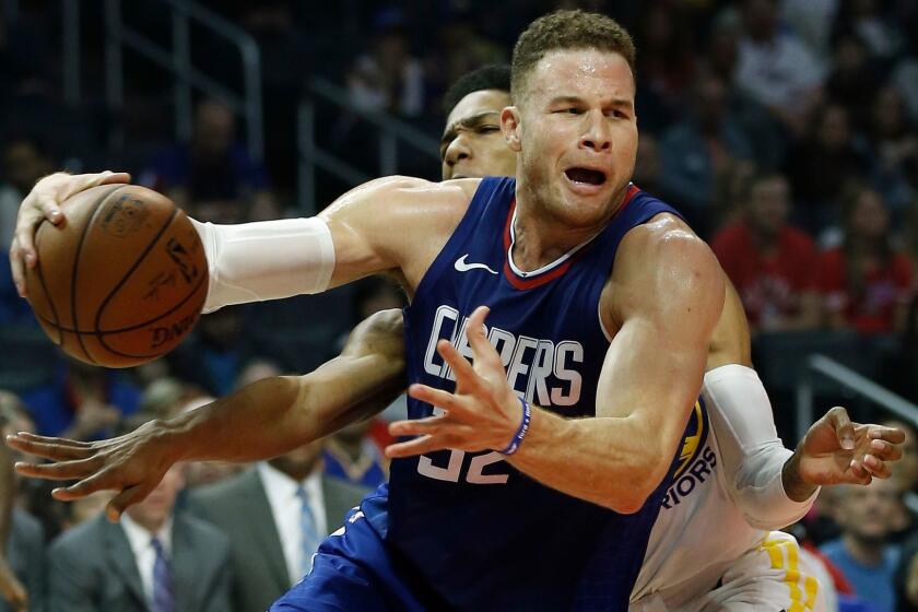 Los Angeles Clippers forward Blake Griffin, right, drives to the basket against Golden State Warriors guard Patrick McCaw during the first half of an NBA basketball game in Los Angeles, Saturday, Jan. 6, 2018. (AP Photo/Alex Gallardo)