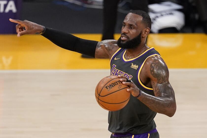 Los Angeles Lakers forward LeBron James dribbles during an NBA basketball game against the Indiana Pacers Friday, March 12, 2021, in Los Angeles. (AP Photo/Marcio Jose Sanchez)