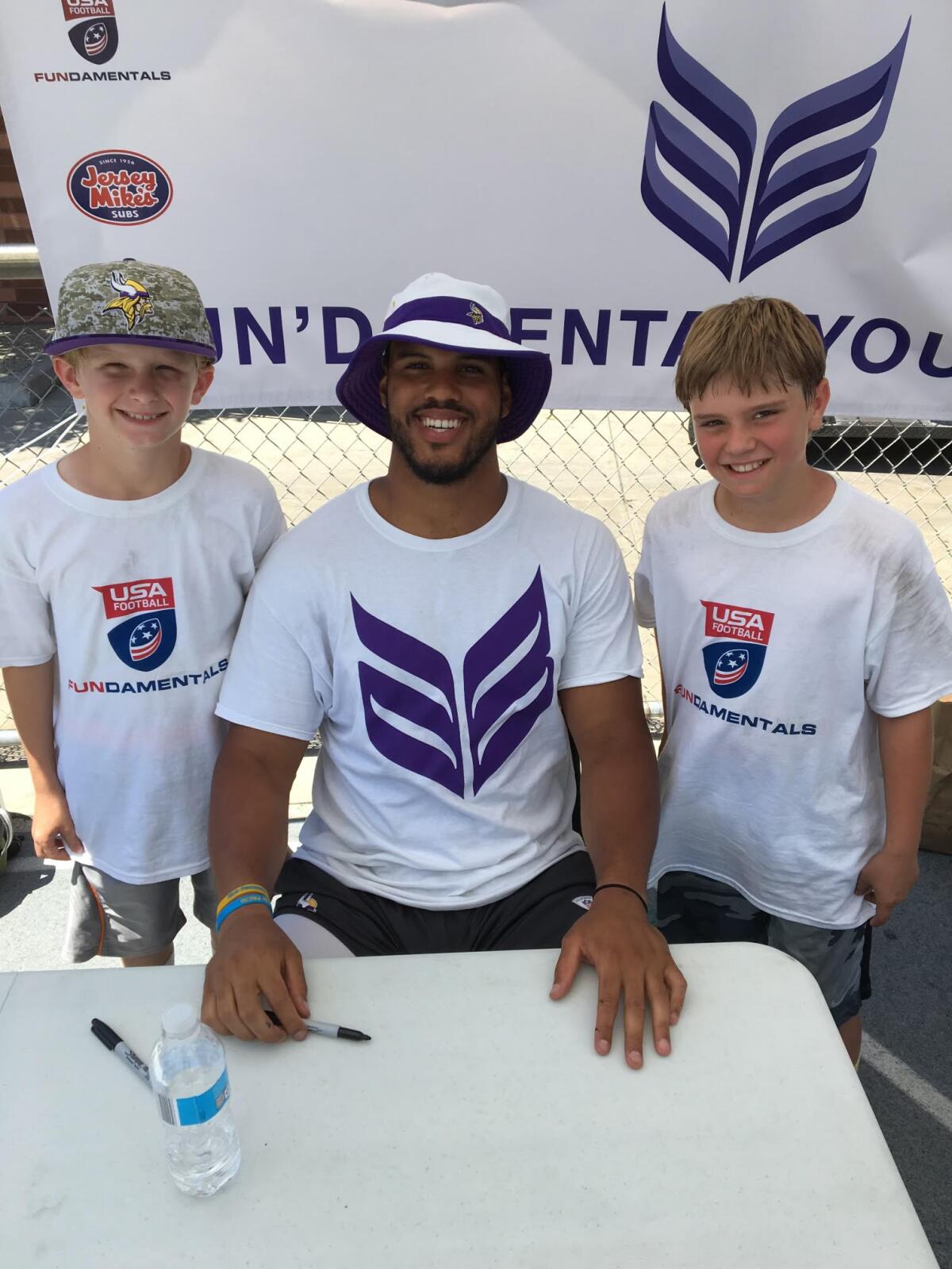 Scott Taylor, left, with his brother Drew and former Loyola and NFL linebacker Anthony Barr at a camp.