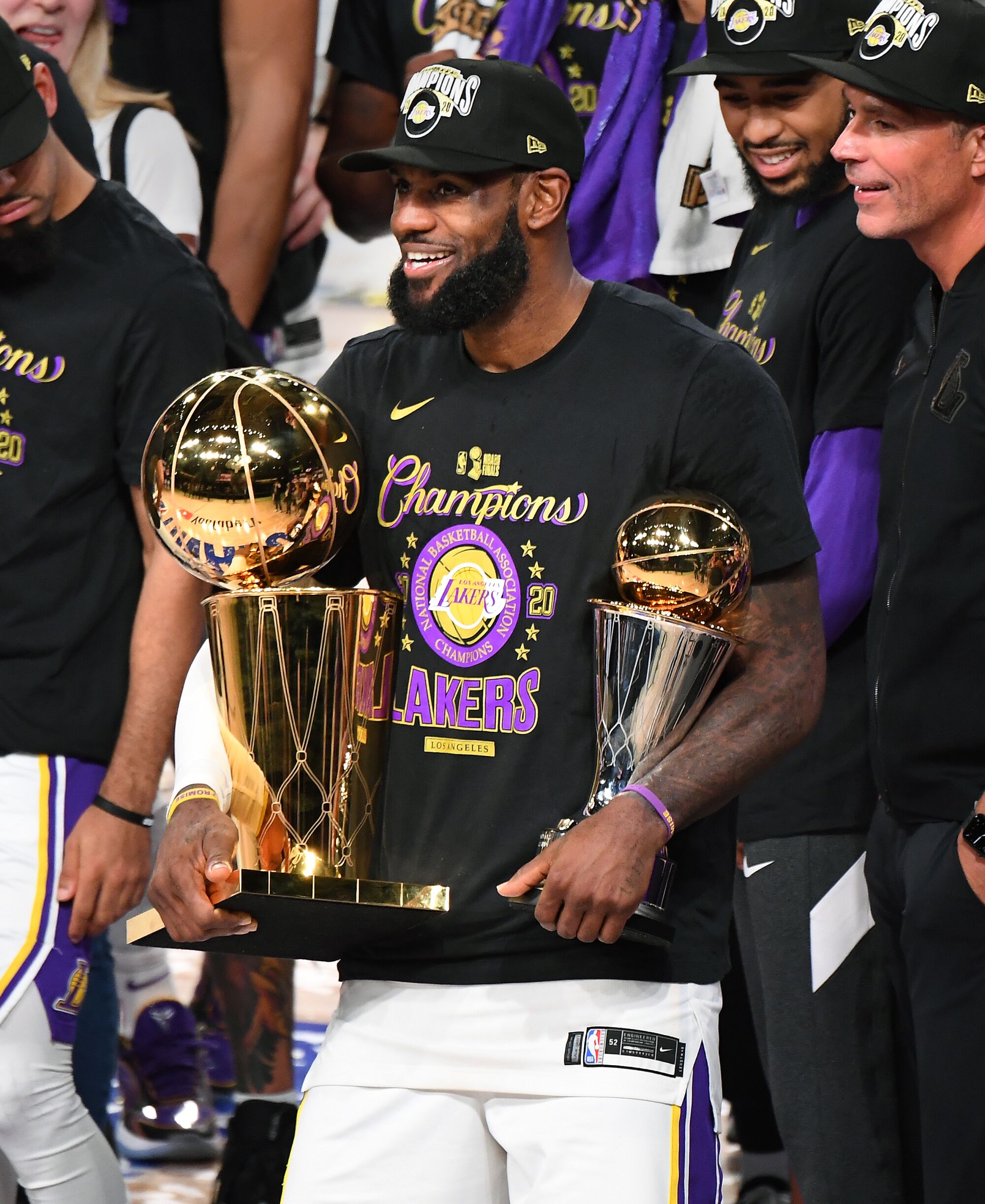 LeBron James holds the MVP and Larry O'Brien trophies after the Lakers defeated the Miami Heat.