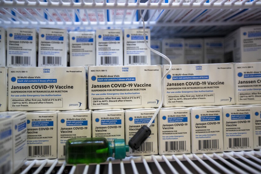 Boxes of Johnson & Johnson's COVID-19 vaccine sit on shelves.