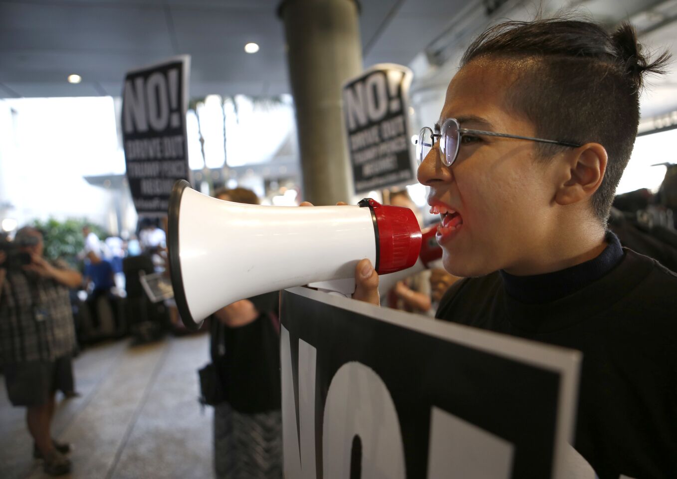 Tala Deloria, 22, protests President Trump's travel ban at Tom Bradley International Terminal.