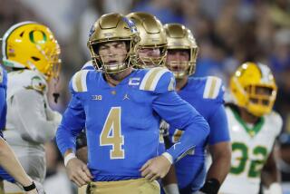 Pasadena, CA - September 28: UCLA quarterback Ethan Garbers, #4, gets up and recovers after being sacked by Oregon defense in the second quarter at the Rose Bowl in Pasadena Saturday, Sept. 28, 2024. (Allen J. Schaben / Los Angeles Times)