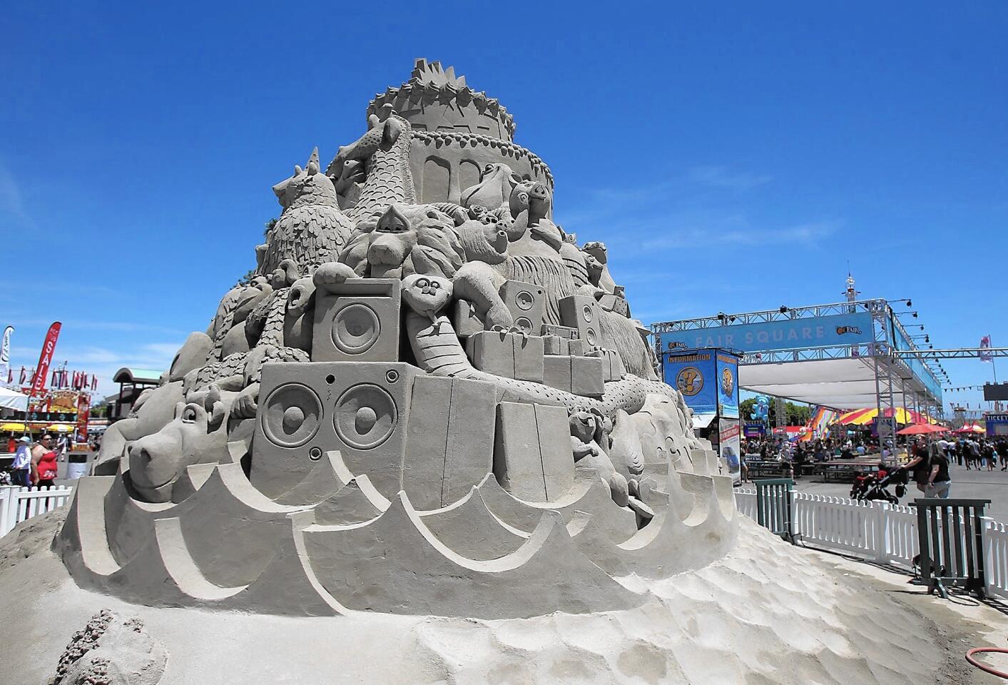 The Sandscapes "One Big Party" sand sculpture is nearly finished in the Fair Square area of the OC Fair on Wednesday.