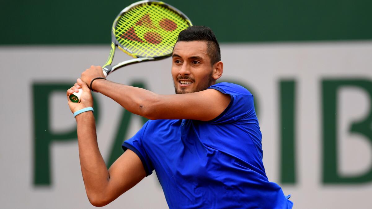 Nick Kyrgios follows through on a shot against Marco Cecchinato at the French Open on Sunday.