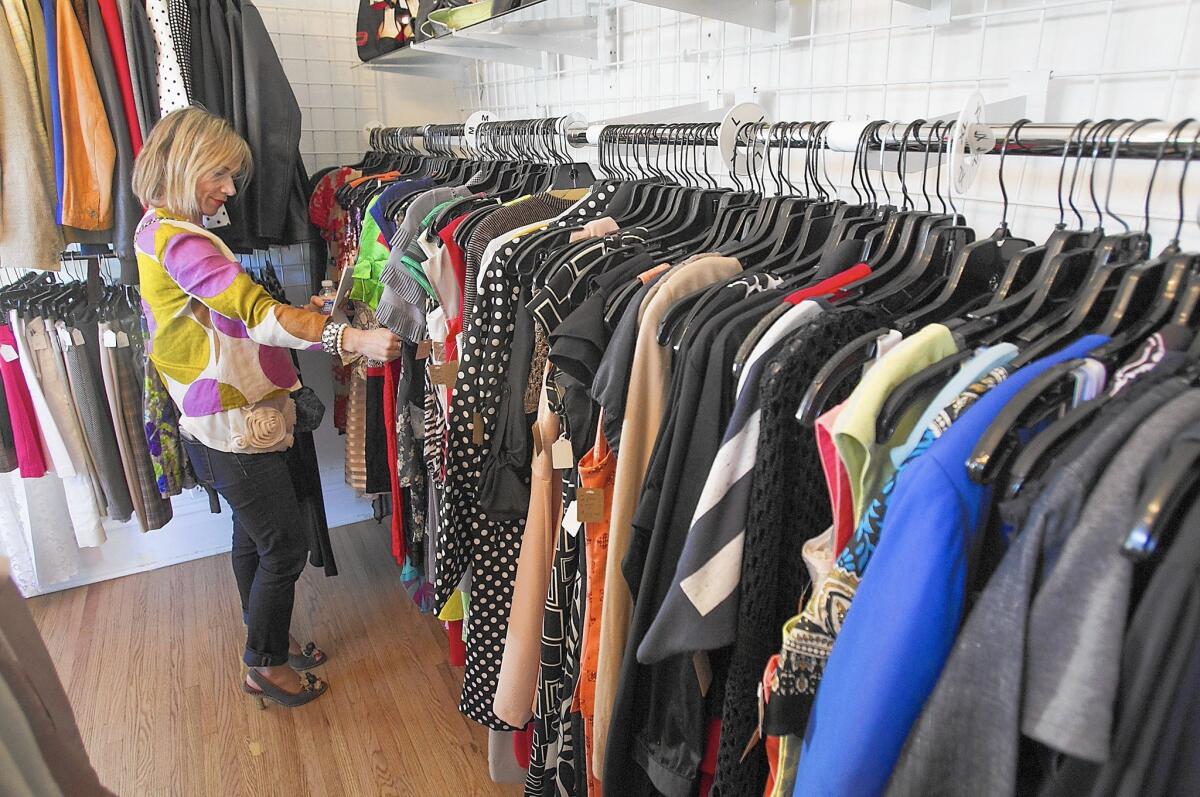 A guest shops in the new resale boutique store The Collection, in Orange.