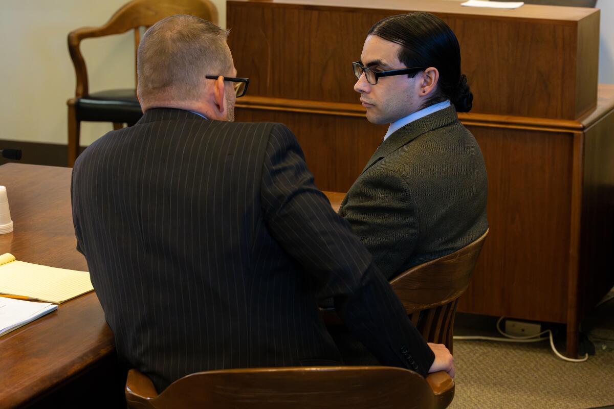 Marcus Anthony Eriz, right, seen at the start of his trial on Jan. 18 in Santa Ana.