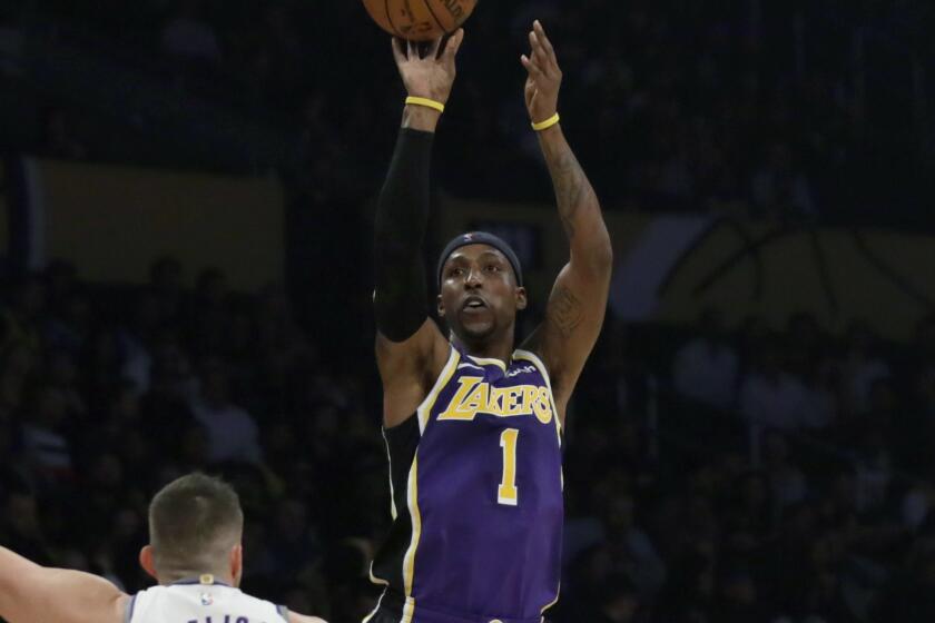 Lakers guard Kentavious Caldwell-Pope (1) shoots over Kings forward Nemanja Bjelica during the first half of their game on Nov. 15, 2019.