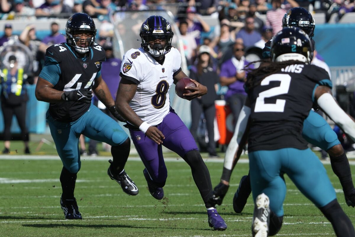 Baltimore Ravens quarterback Lamar Jackson (8) runs the ball during the first half of an NFL football game against the Jacksonville Jaguars, Sunday, Nov. 27, 2022, in Jacksonville, Fla. (AP Photo/John Raoux)