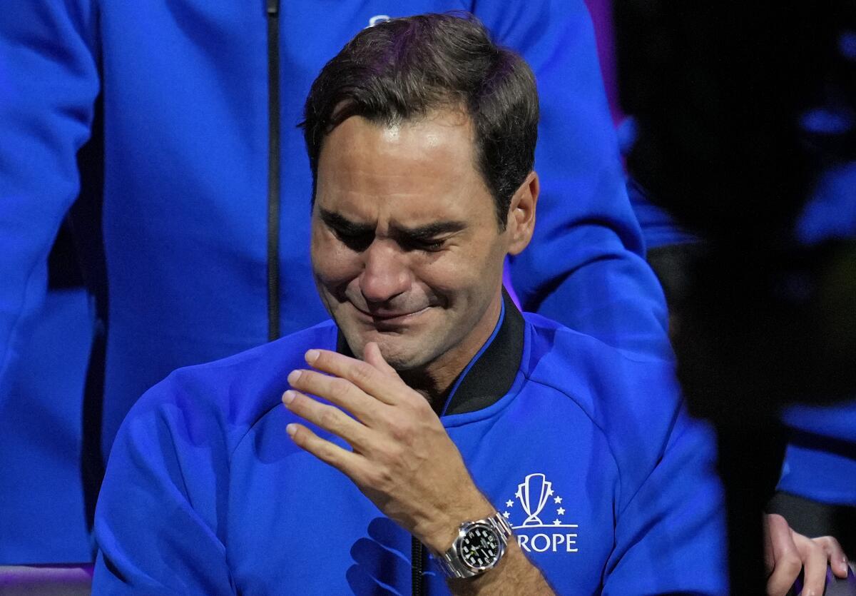 An emotional Roger Federer of Team Europe sits alongside his playing partner Rafael Nadal.