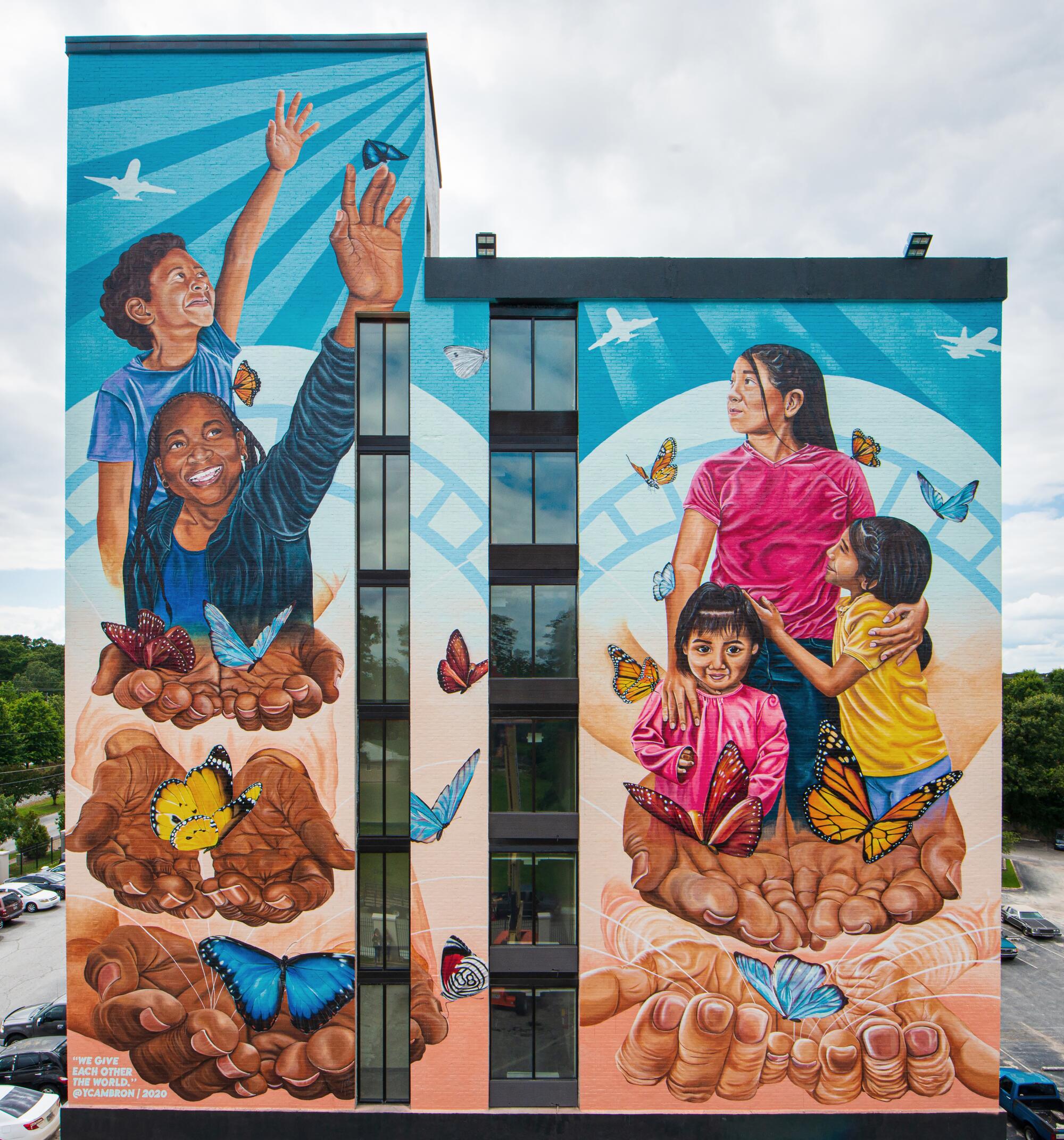 "We Give Each Other the World" is a mural inspired by the stories and experiences of people who live in Hapeville, Ga.