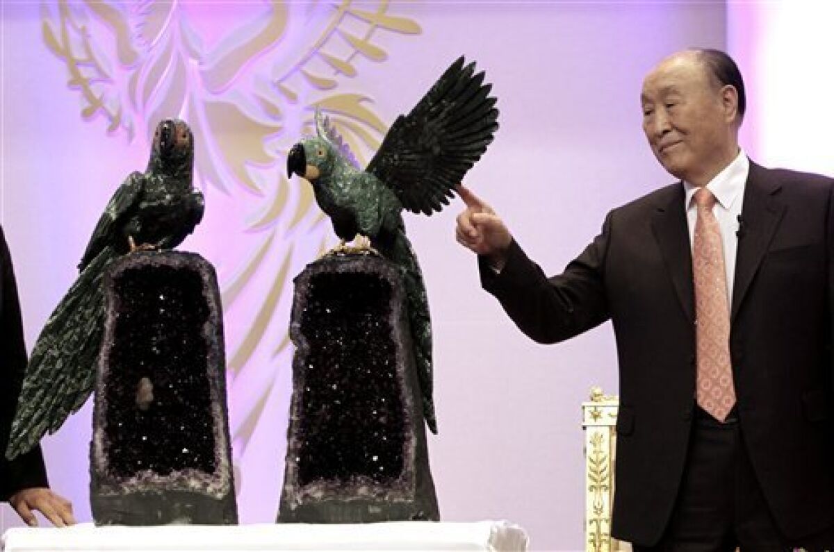 Rev. Moon Sun-myung, founder of the controversial Unification Church, watches a gift presented to him at his birthday party in Gapyeong, South Korea, Friday, Feb. 19, 2010. Guests from around the world sang, prayed and shouted "Hurrah" Friday to celebrate the Rev. Moon's 90th birthday as he is preparing to hand over control of the Unification Church to Harvard-educated son, Rev. Moon Hyung-jin. (AP Photo/Ahn Young-joon)