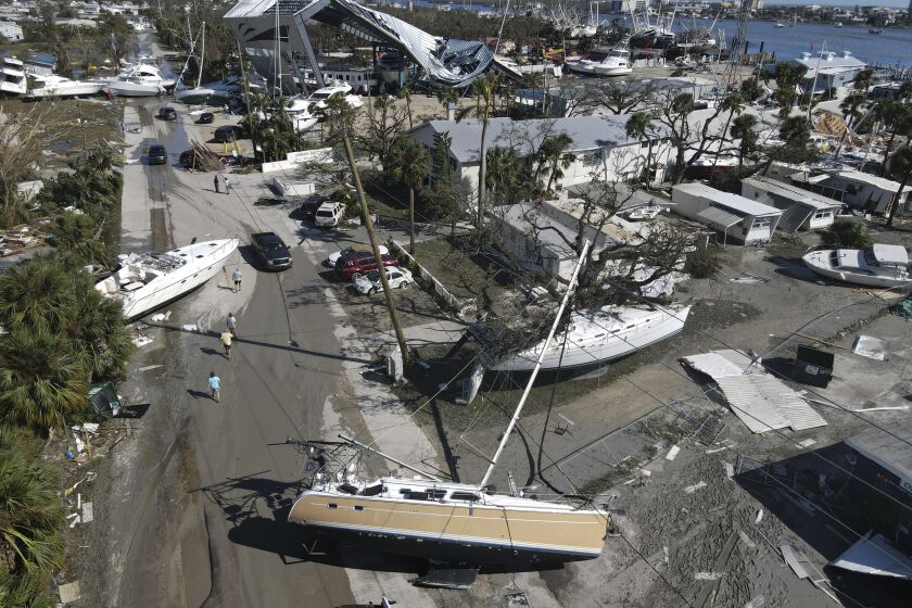 Boats lie scattered amidst mobile homes after the passage of Hurricane Ian, in the San Carlos area of Fort Myers Beach, Fla., Thursday, Sept. 29, 2022. (AP Photo/Rebecca Blackwell)