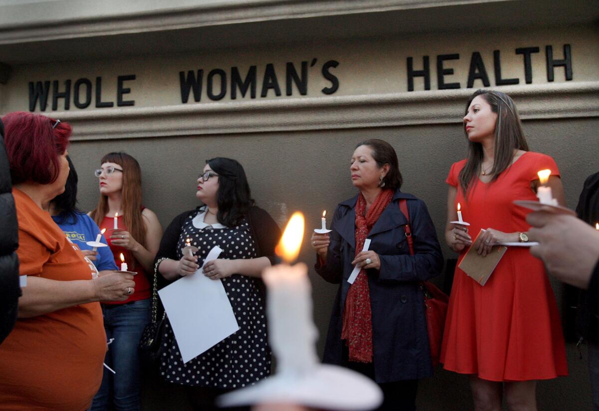 People held a candle light vigil in front of the Whole Women's HealthClinic in McAllen, Texas in March, above. The clinic is reopening after a federal judge blocked part of a sweeping new law restricting abortions.