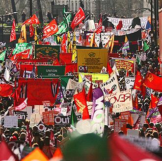 Demonstrators take part in the "Put People First" march through central London.