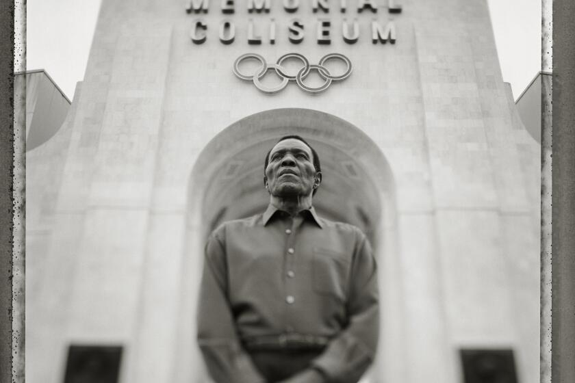 084944.CA.0721.legacy - Rafer Johnson, Olympic decathalon gold medalist and torch bearer at the 1984 Summer Olympic Games photographed in Memorial Coliseum in Exposition Park in Los Angeles under the torch he lit 20 years ago.