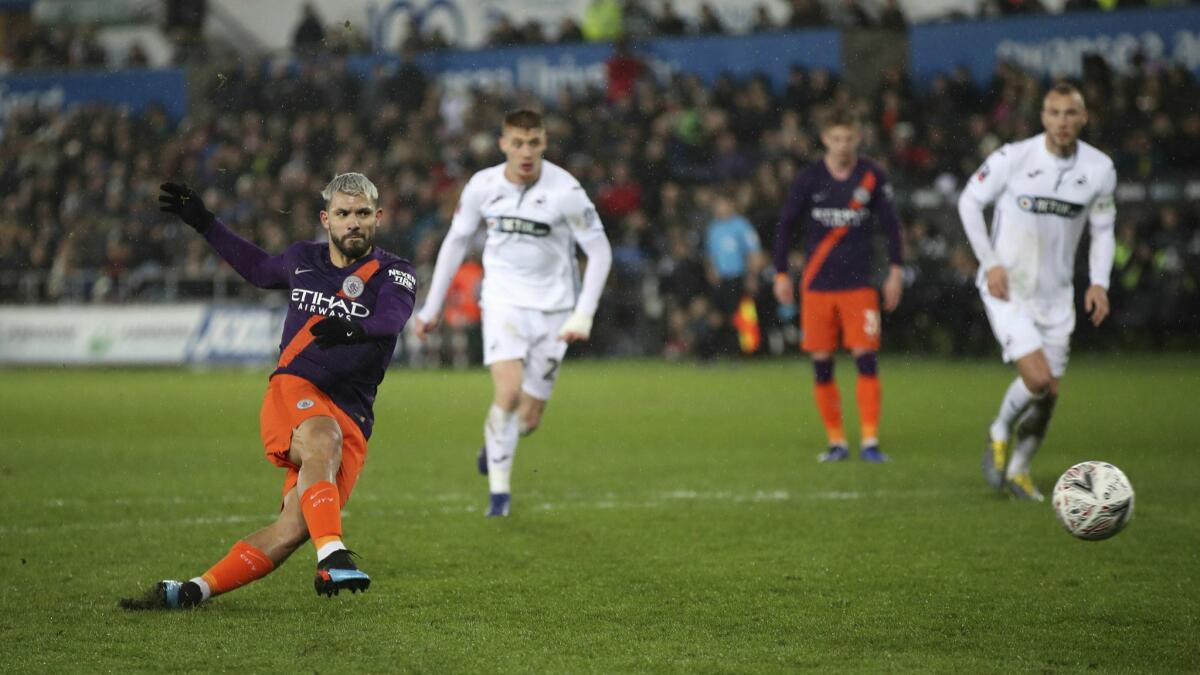 Manchester City's Sergio Aguero goes for a penalty kick during their English FA Cup quarterfinal soccer match against Swansea City on March 16.