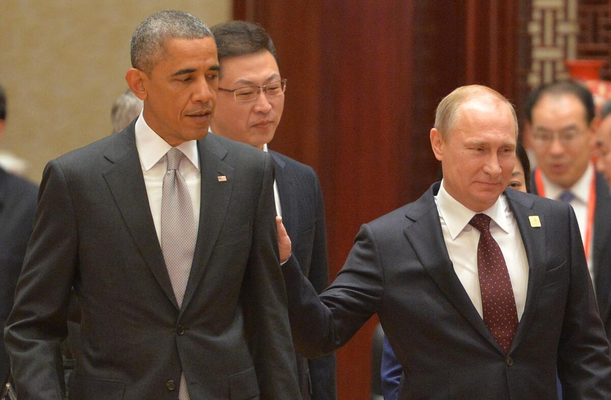 Who's the big cheese now? U.S. President Barack Obama and Russian President Vladimir Putin in a rare personal encounter at November's APEC summit in Beijing.