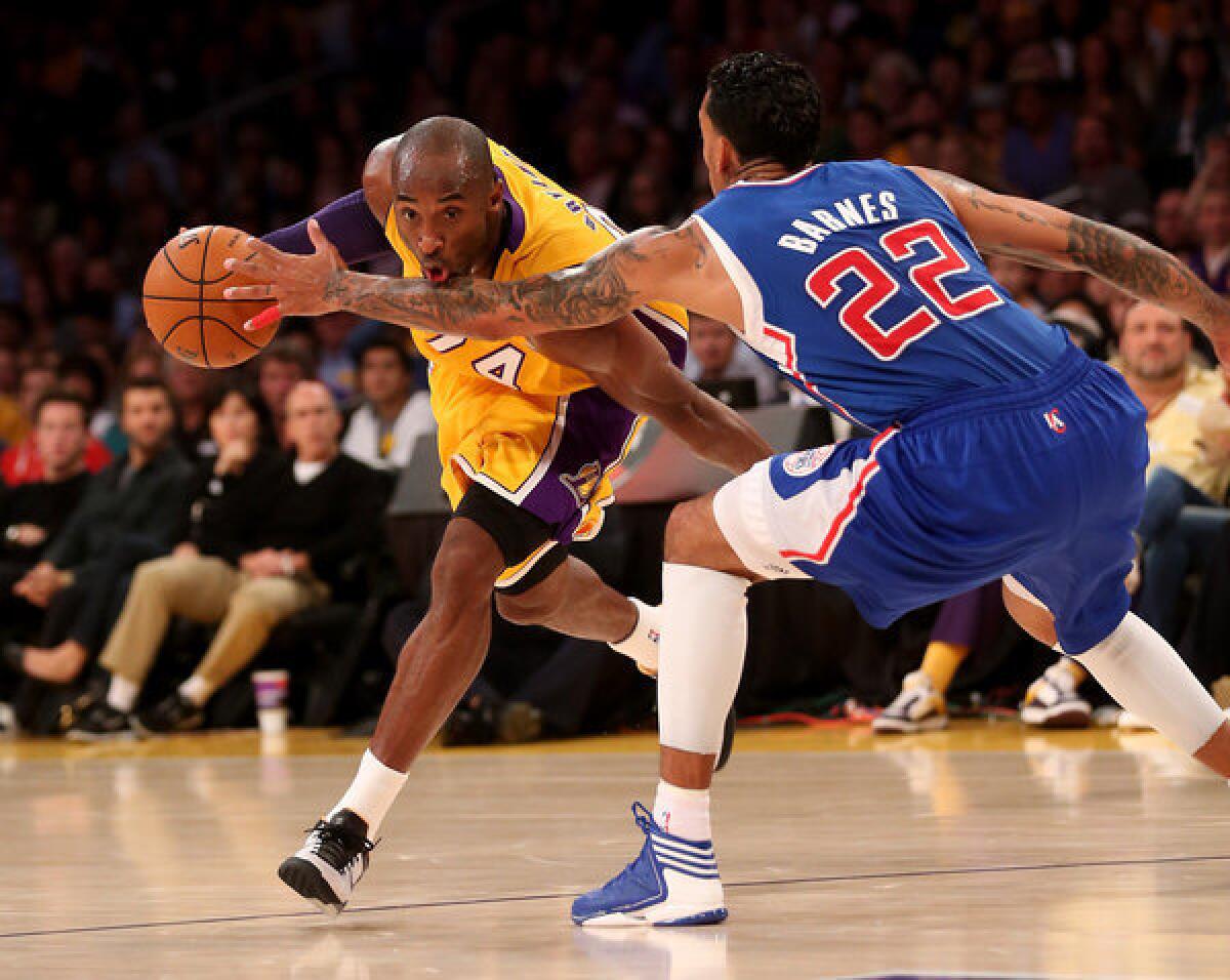 Lakers guard Kobe Bryant drives against Clippers forward Matt Barnes. Steve Nash wasn't on the court for the game.
