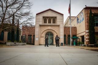 Beverly Hills, CA - February 26: Security guards stand outside at Beverly Vista Middle School on Monday, Feb. 26, 2024 in Beverly Hills, CA. (Jason Armond / Los Angeles Times)