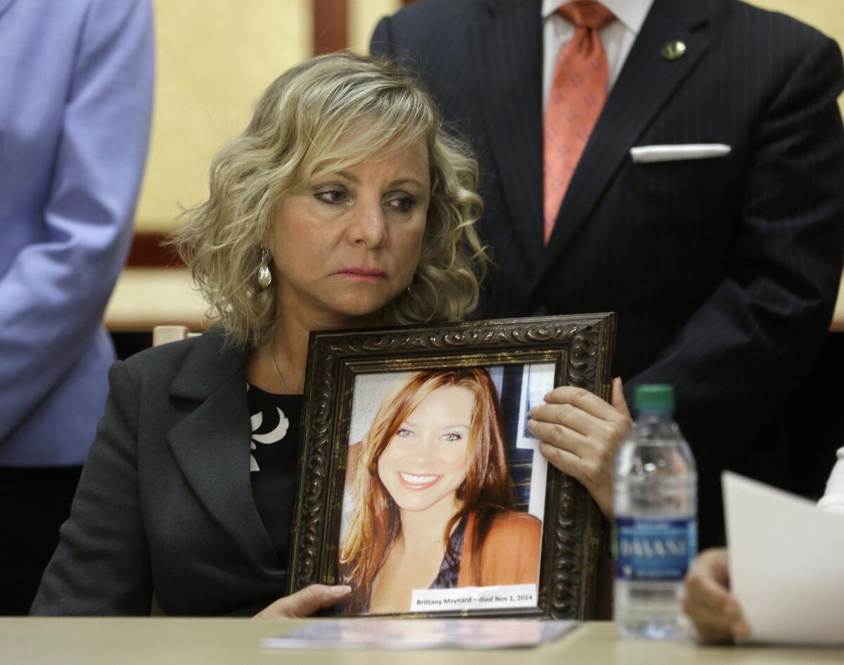 Debbie Ziegler holds a photo of her daughter -- Brittany Maynard, the California woman with brain cancer who moved to Oregon to legally end her life last fall -- during a news conference to announce the reintroduction of right-to-die legislation in August.