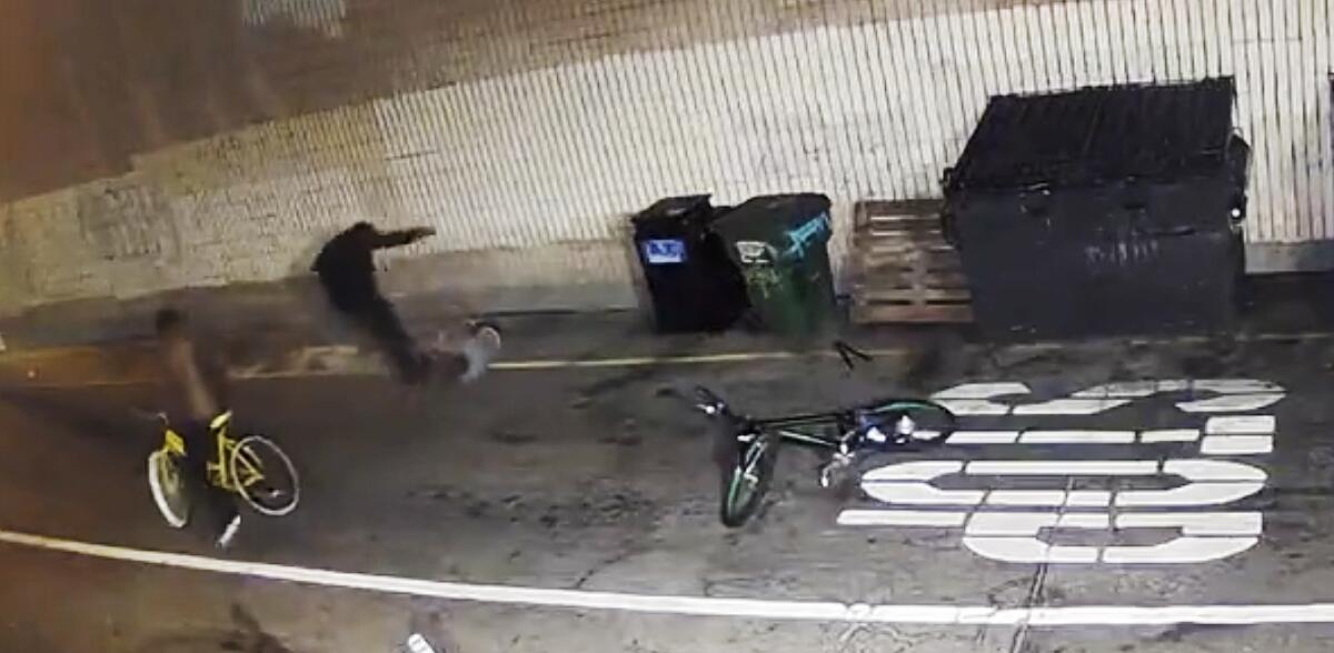 An image from video shows a man beating another in a tunnel.