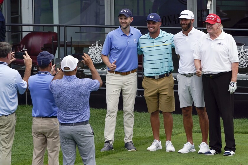 Left to right: Eric Trump, Bryson DeChambeau, Dustin Johnson and Donald Trump pose for a photograph.