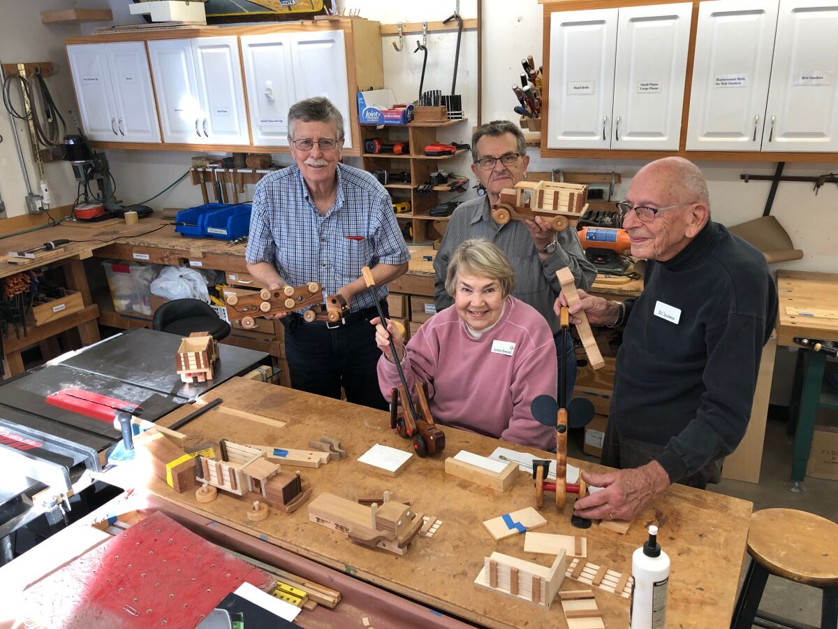 (From left) Tom Woodbury, Carolyn Rowland, Ron Neuman and Bill Speakman are part of the woodworking team at La Costa Glen in Carlsbad.