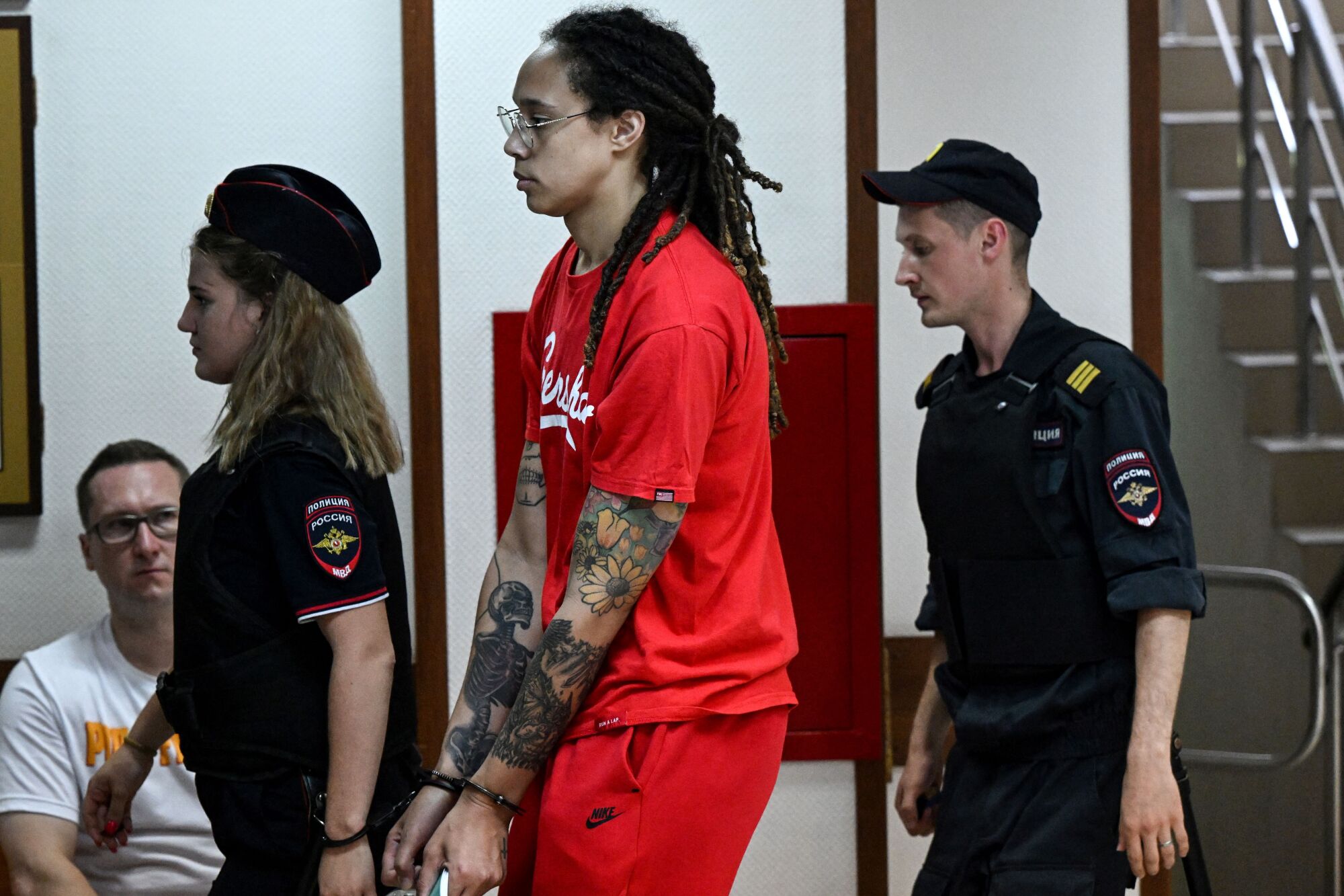 Griner is escorted into the courtroom 