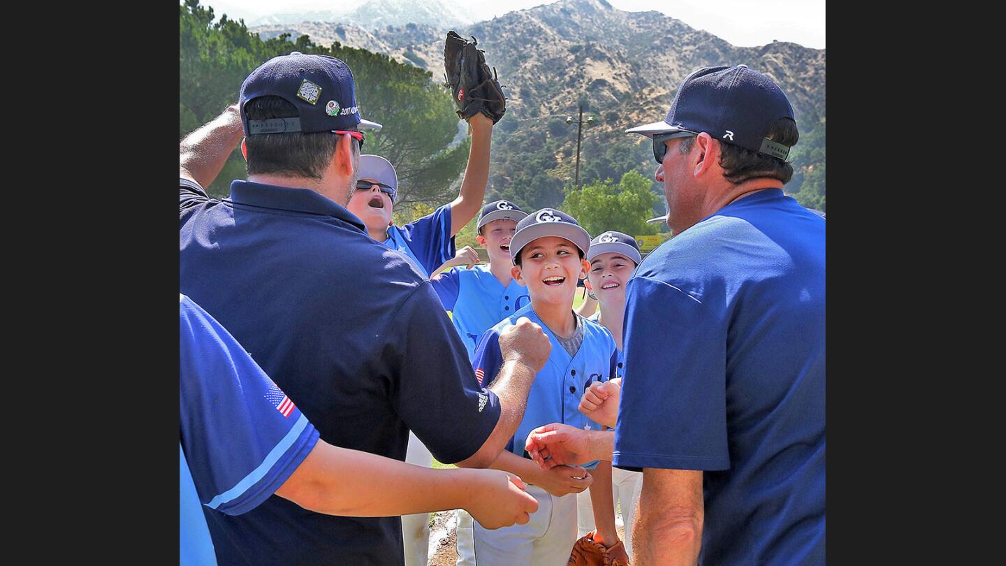 Crescenta Valley's team, with pitcher Tyler Cofre in the center, celebrate their victory against Vaquero in the 11-year-old majors Little League District 16 championship at Tujunga Little League Fields in Tujunga on Saturday, July 1, 2017. Crescenta Valley won the game 13-0.