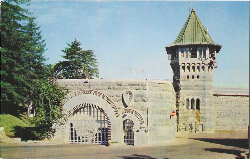 The foreboding exterior of Folsom Prison, with its arched gates, stone walls and imposing tower
