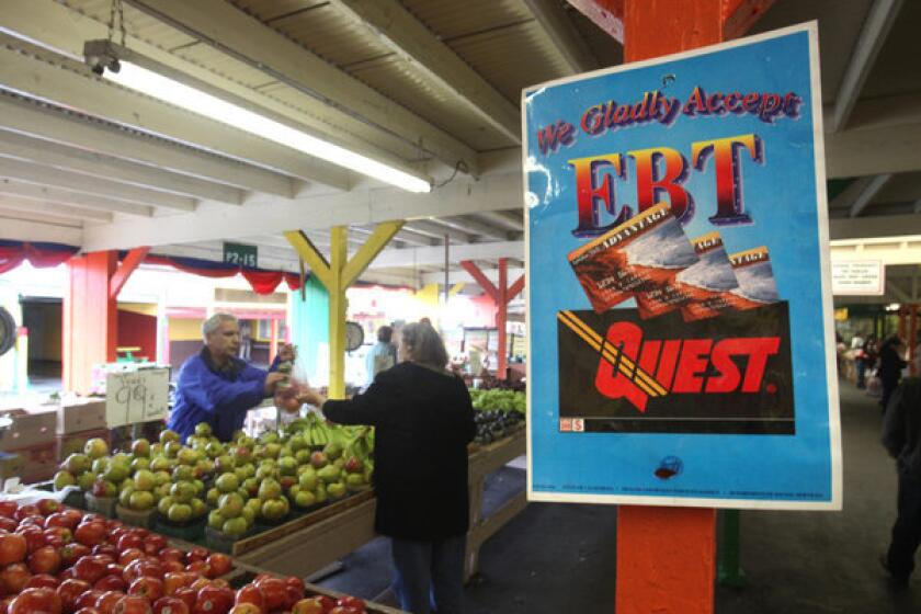 A sign announces the acceptance of food stamps at a farmers market in Roseville, Calif. The House has rejected a five-year, half-trillion-dollar farm bill that would have cut $2 billion annually from food stamps.