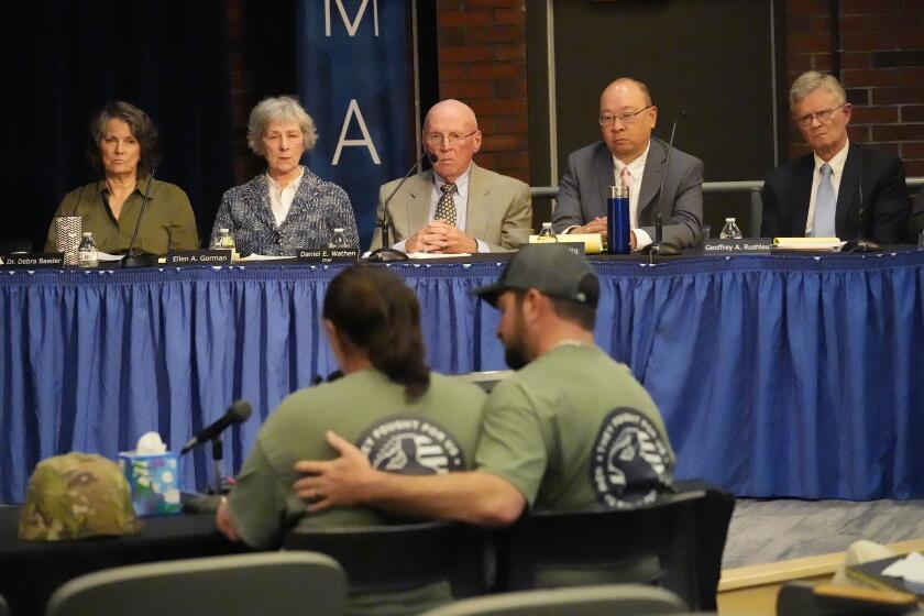 FILE — Members of the independent commission investigating the law enforcement response to the mass shooting in Lewiston, Maine, listen as Nicole Herling, below left, sister of shooter Robert Card, testifies Thursday, May 16, 2024, in Augusta, Maine. (AP Photo/Robert F. Bukaty, File)