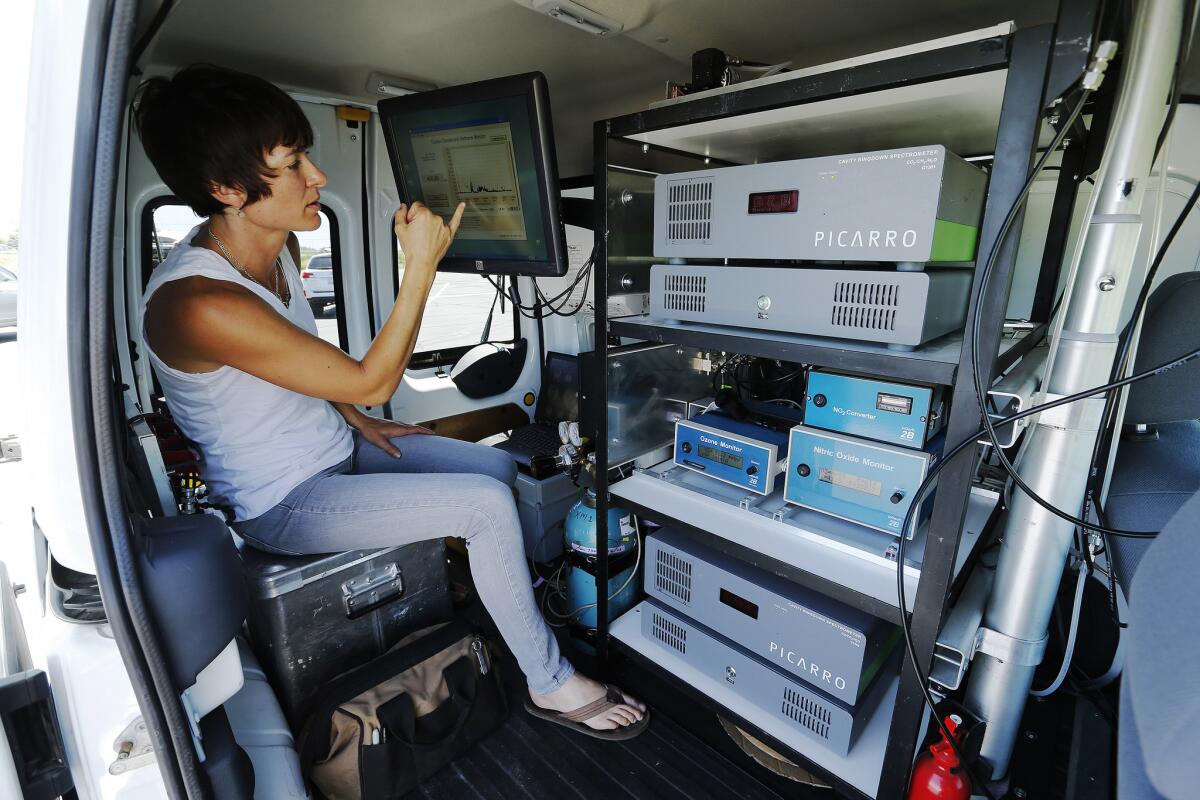 A post-doctoral scholar from the University of Utah looks over data as part of a study on ozone levels being conducted at the Ogden Bay Waterfowl Management Area near the Great Salt Lake in Salt Lake City in June.