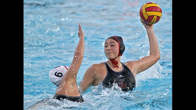 Burroughs High School girls water polo player #7 Bianca Sanchez takes a shot on goal even under pressure from Glendale High School player #6 Arpa Shahbazian in Pacific League Tournament semifinal match at Arcadia High School, in Arcadia on Tuesday, Feb. 6, 2018. Burroughs won the game 10-6.