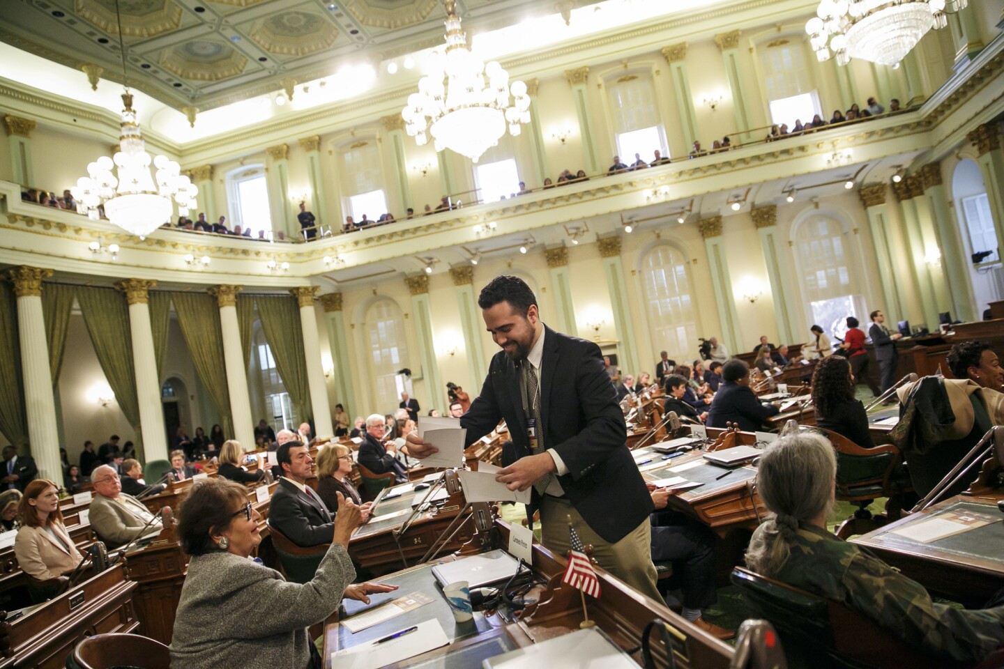 Andres Ramos collect the ballots voted by the members of the electoral college at the state Capitol in Sacramento.